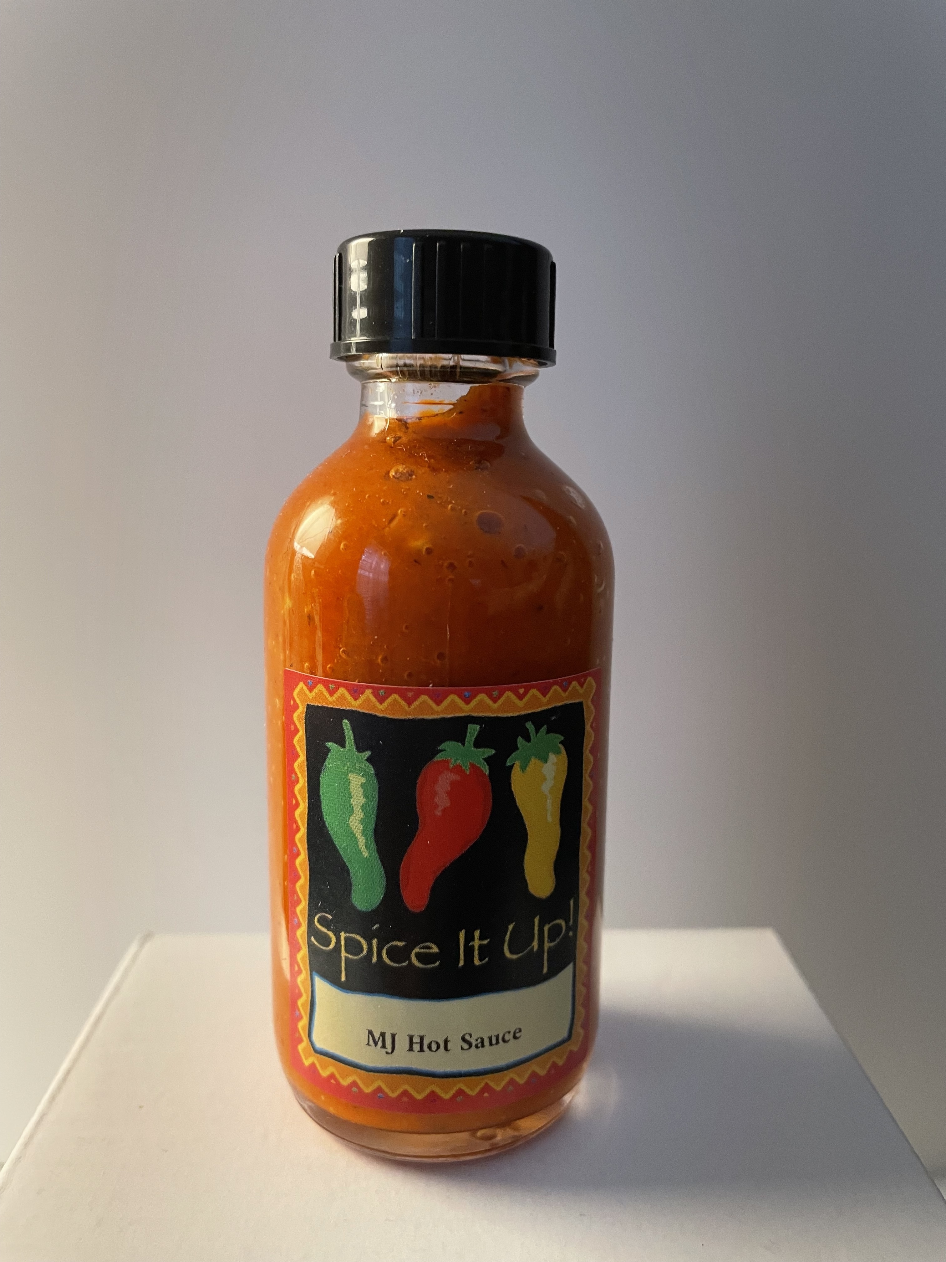 Collection of MJ's Hot Sauce bottles arranged artistically